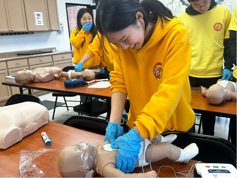 Students interacting with each other and the instructor during a hands-on BLS training class.